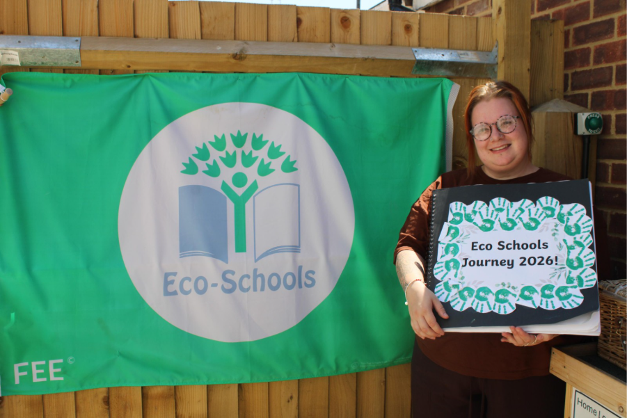 College Town Day Nursery Deputy Manager holding Eco-Schools book