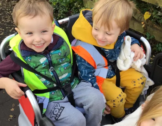 Kiddi Caru Exteter Children enjoying an outing in the buggy