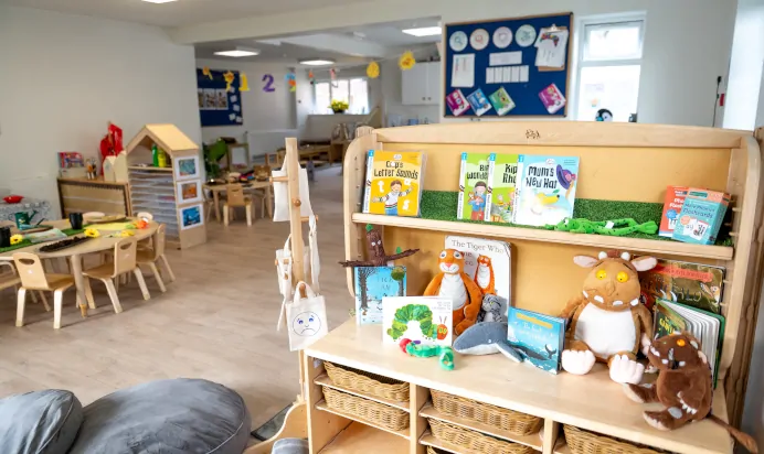 Books on a shelf with stuffed toys at Little Acorns Day Nursery Preschool Stoneygate