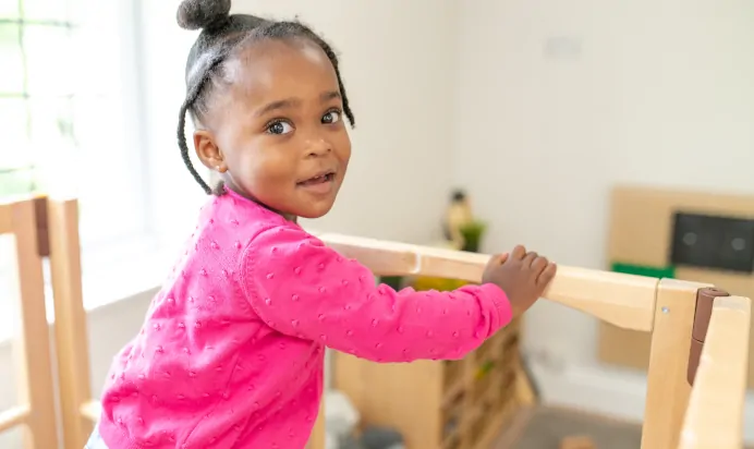 Child about to go down wooden slide at Little Acorns Day Nursery Preschool Stoneygate
