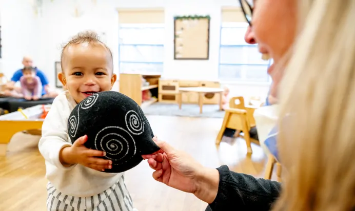 Child having fun with key worker at Kiddi Caru Day Nursery Preschool Torquay