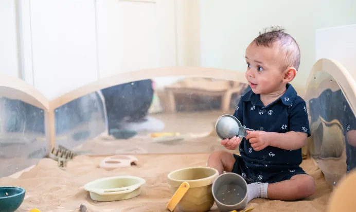 Child in sand pit at Kiddi Caru Day Nursery Preschool Leighton Buzzard