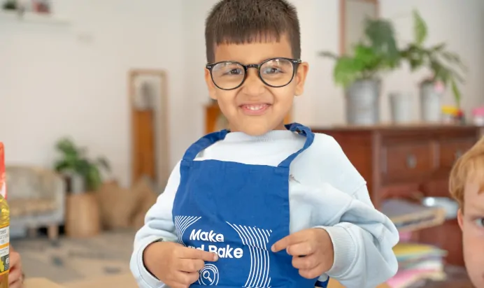 Child laughing and pulling a face at The Kiddi Caru Day Nursery Preschool Grange Park
