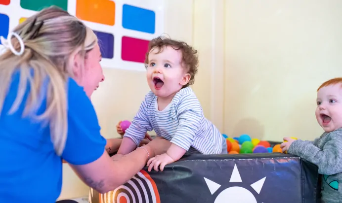 Child laughing with key worker at Kiddi Caru Day Nursery Preschool Plympton Plymouth