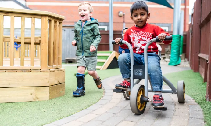 Child on tricycle at Kiddi Caru Day Nursery Preschool Peterborough