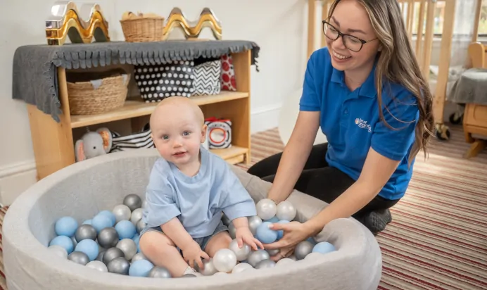 Child playing in ball pit at The Old Barn Day Nursery Preschool Narborough