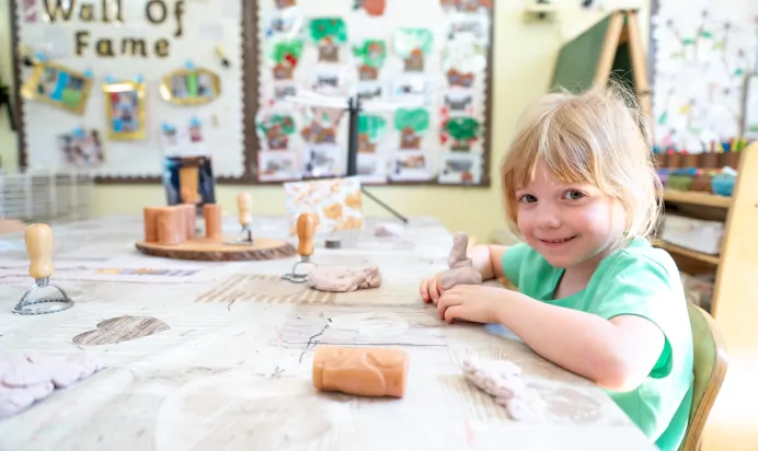 Child playing with clay at Kiddi Caru Day Nursery Preschool Whiteley