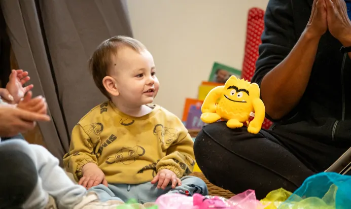 Child playing with key workers and stuffed toy at Charnwood Day Nursery Preschool Shepshed Loughborough