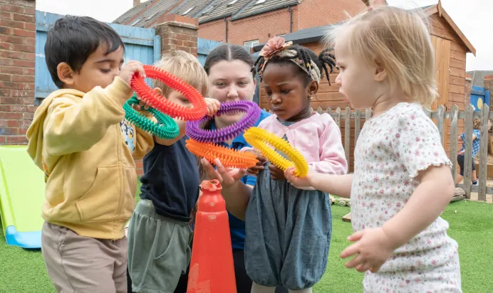 Children playing with key worker at The Kiddi Caru Day Nursery Preschool Grange Park