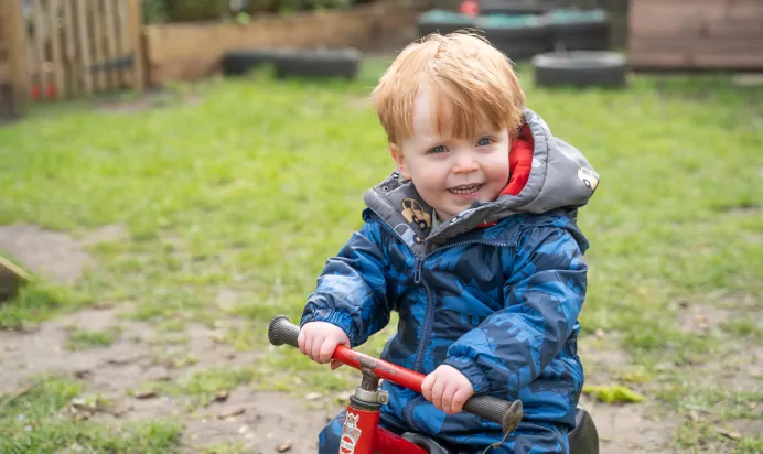 Child riding tricycle at The Melton Mowbray Day Nursery Preschool Leicester