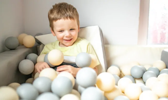Child sitting in ball pit at Charnwood Day Nursery Preschool Shepshed Loughborough