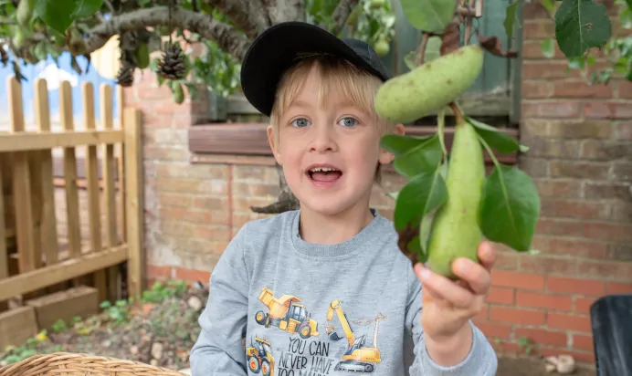 Child smiling at The Kiddi Caru Day Nursery Preschool Grange Park
