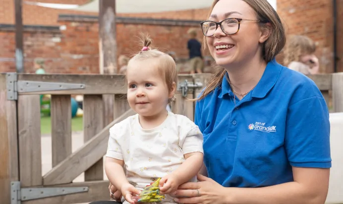 Child smiling with key worker at The Old Barn Day Nursery Preschool Narborough