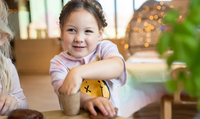 Child with play dough at The Old Barn Day Nursery Preschool Narborough