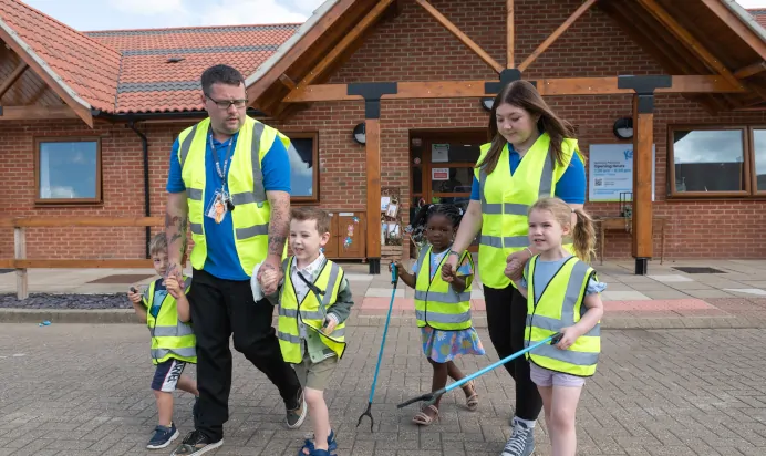 Children and key worker in high vis going on a trip at Kiddi Caru Day Nursery Preschool Walnut Tree Milton Keynes