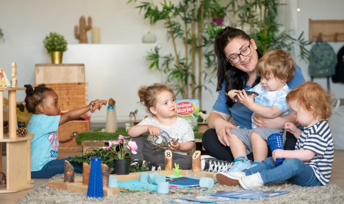 Children and key worker playing at Kiddi Caru Day Nursery Preschool Walnut Tree Milton Keynes