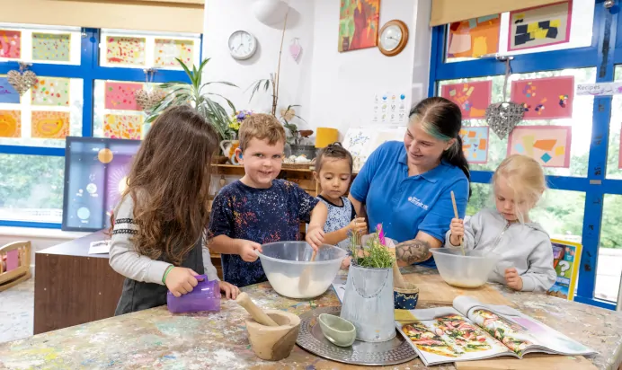 Children baking in interactive space at The Kiddi Caru Day Nursery Preschool Burgess Hill