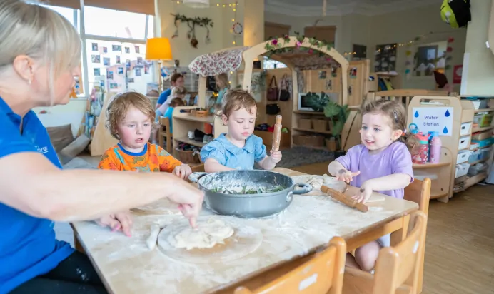 Children baking with key worker at Kiddi Caru Day Nursery Preschool Leighton Buzzard