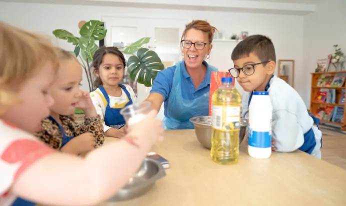 Children baking with key worker at The Kiddi Caru Day Nursery Preschool Grange Park