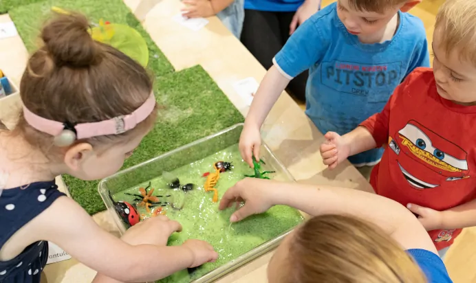 Children collaborating in interactive space with slime at The Kiddi Caru Day Nursery Preschool Taunton