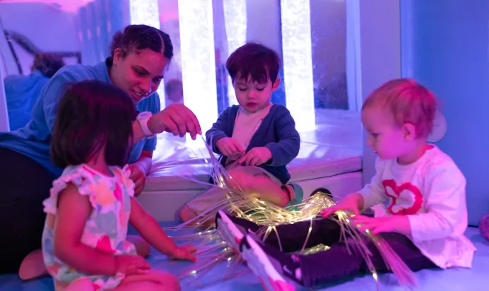 Children in colourful interactive space at The Kiddi Caru Day Nursery Preschool Grange Park