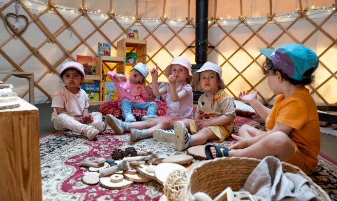 Children inside canvas tent at Kiddi Caru Day Nursery Preschool Wellingborough