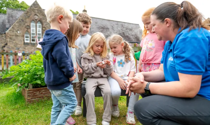 Children looking at an egg at Whitwick Day Nursery Preschool Coalville