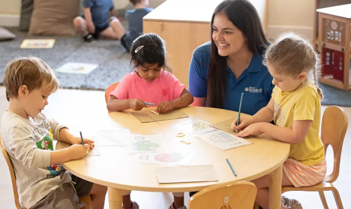Children painting together at The Kiddi Caru Day Nursery Preschool Taunton