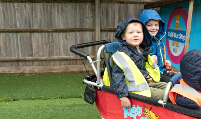 Children playing outside together at The Kiddi Caru Day Nursery Preschool Burgess Hill