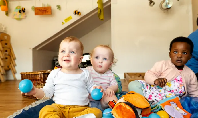 Children playing with balls and sensory toys at Kiddi Caru Day Nursery Preschool Wellingborough