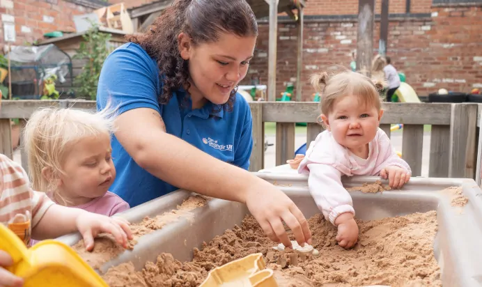 Children playing with sand pit at The Old Barn Day Nursery Preschool Narborough