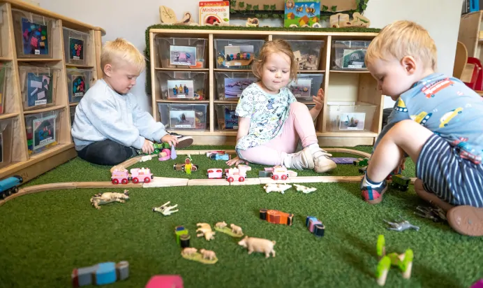 Children playing with toy trains at Kiddi Caru Day Nursery Preschool Torquay
