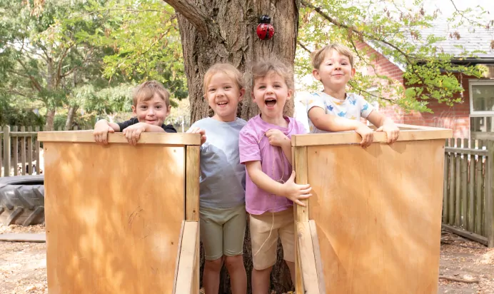 Children smiling outside at The Kiddi Caru Day Nursery Preschool Writtle