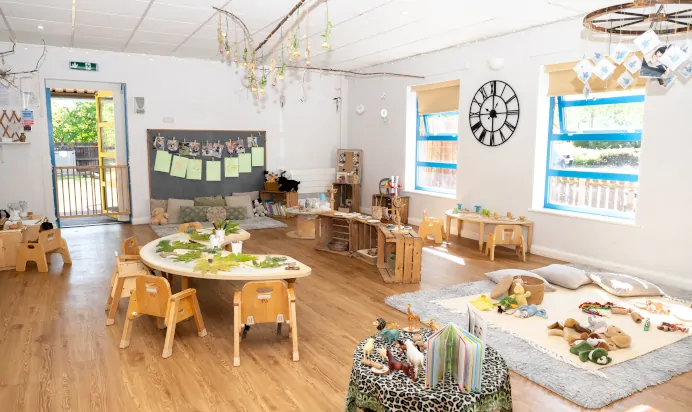 Indoor activity area with toys and book at Kiddi Caru Day Nursery Preschool Wellingborough