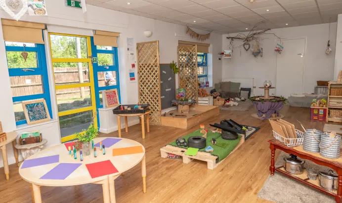 Indoor activity area with toys and book corner at Kiddi Caru Day Nursery Preschool Wellingborough