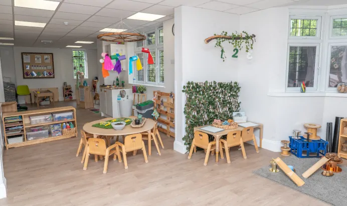 Indoor classroom with tables and sand pit at Little Acorns Day Nursery Preschool Stoneygate