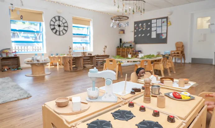 Indoor play kitchen with toy stand mixer at Kiddi Caru Day Nursery Preschool Wellingborough