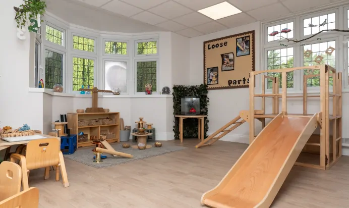 Indoor space with wooden slide and toys at Little Acorns Day Nursery Preschool Stoneygate