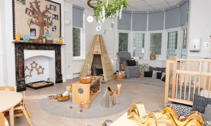 Indoor space with wooden teepee at Little Acorns Day Nursery Preschool Stoneygate