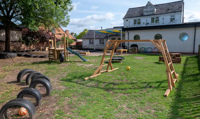 Interactive outdoor space with playground equipment at The Laurels Day Nursery Preschool Queniborough