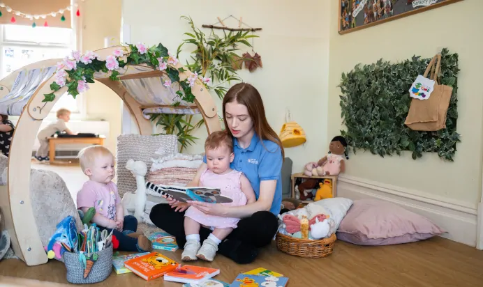 Key worker reading to children at Kiddi Caru Day Nursery Preschool Leighton Buzzard