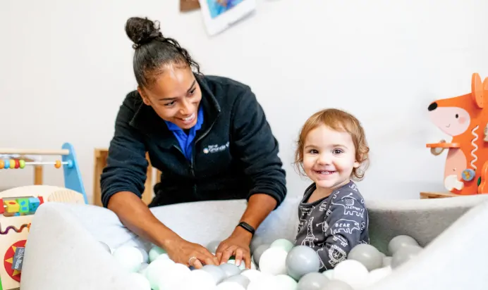Key worker with child in a ball pit at Charnwood Day Nursery Preschool Shepshed Loughborough