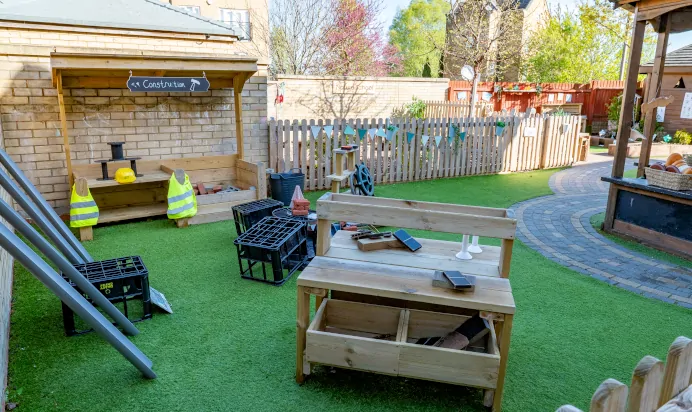 Outdoor garden with construction play area at Kiddi Caru Day Nursery Preschool Caldecotte Milton Keynes