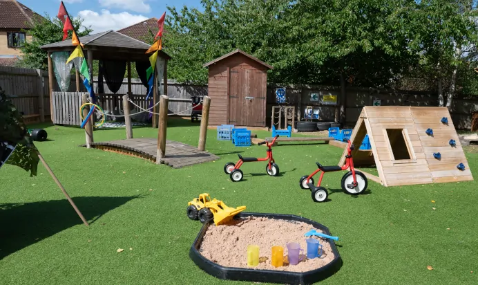 Outdoor play area with sand pit at Kiddi Caru Day Nursery Preschool Walnut Tree Milton Keynes