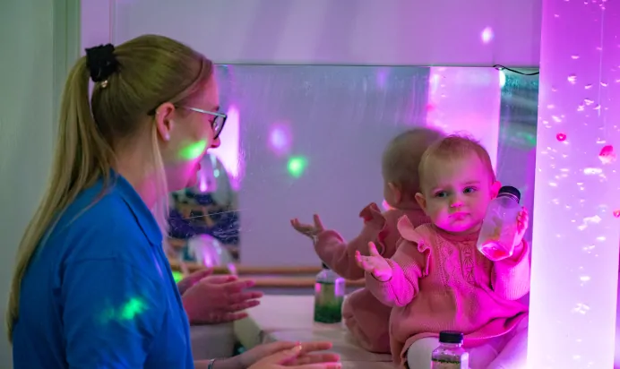 Small child playing with key worker at Kiddi Caru Day Nursery Preschool Torquay