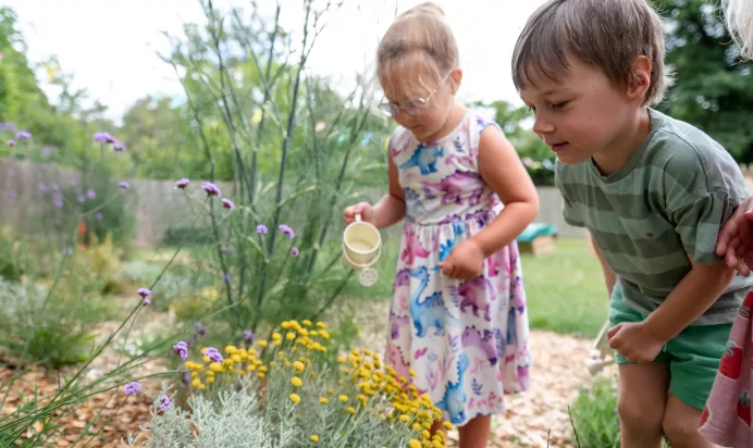 Children looking after flowers at Kiddi Caru Day Nursery Preschool Fareham