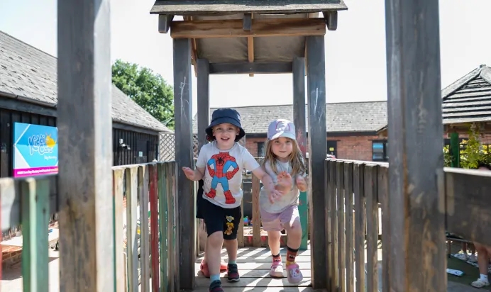 Children running on climbing frame at Kiddi Caru Day Nursery Preschool Market Ower