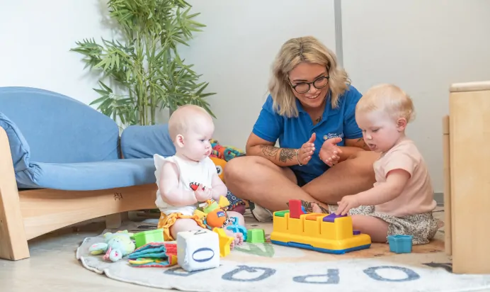 Key worker clapping for child at Kiddi Caru Day Nursery Preschool Market Ower
