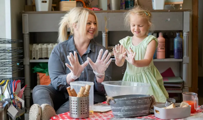 Child and key worker making dough at Dicky Birds Nursery Preschool Queens Road Wimbledon London
