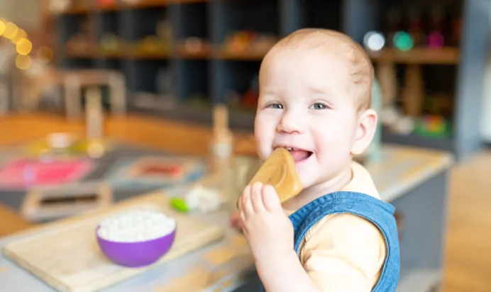 Child pretending to eat food at Dicky Birds Nursery Preschool Claremont Road Surbiton
